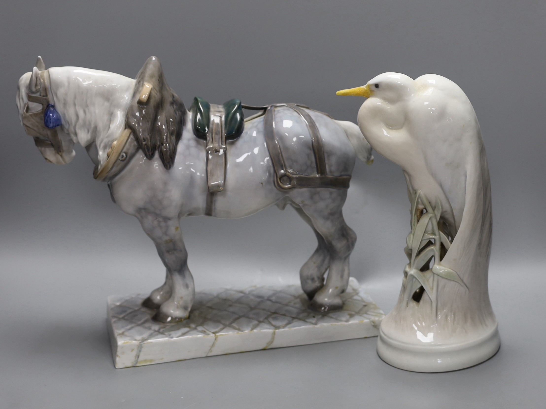 A Royal Copenhagen ceramic model of a shire horse, signed and dated and a similar crane, both restored